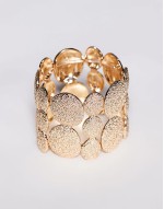 bangle bracelet with textured pebble detail in gold tone